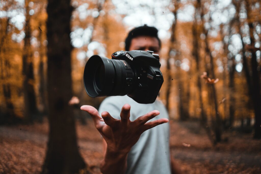 Camera floating in a man's hand in the woods